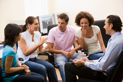 man-giving-lecture-to-four-people