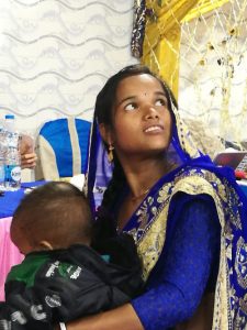 Young mother receives treatment for her slum during the Calcutta slum Project, with homeopathic medicine