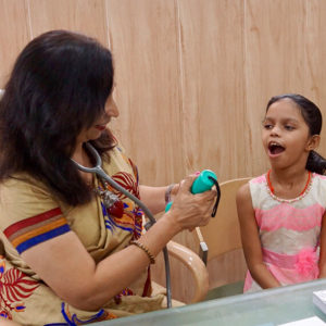 Dr Sujata Naik examines a child in homeopathy clinic